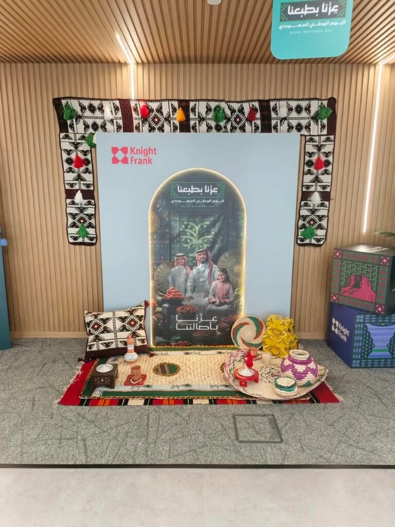 Action8 project: Saudi National Day setup with a traditional Sadu weave hanging on a slatted wooden wall, produced in Riyadh