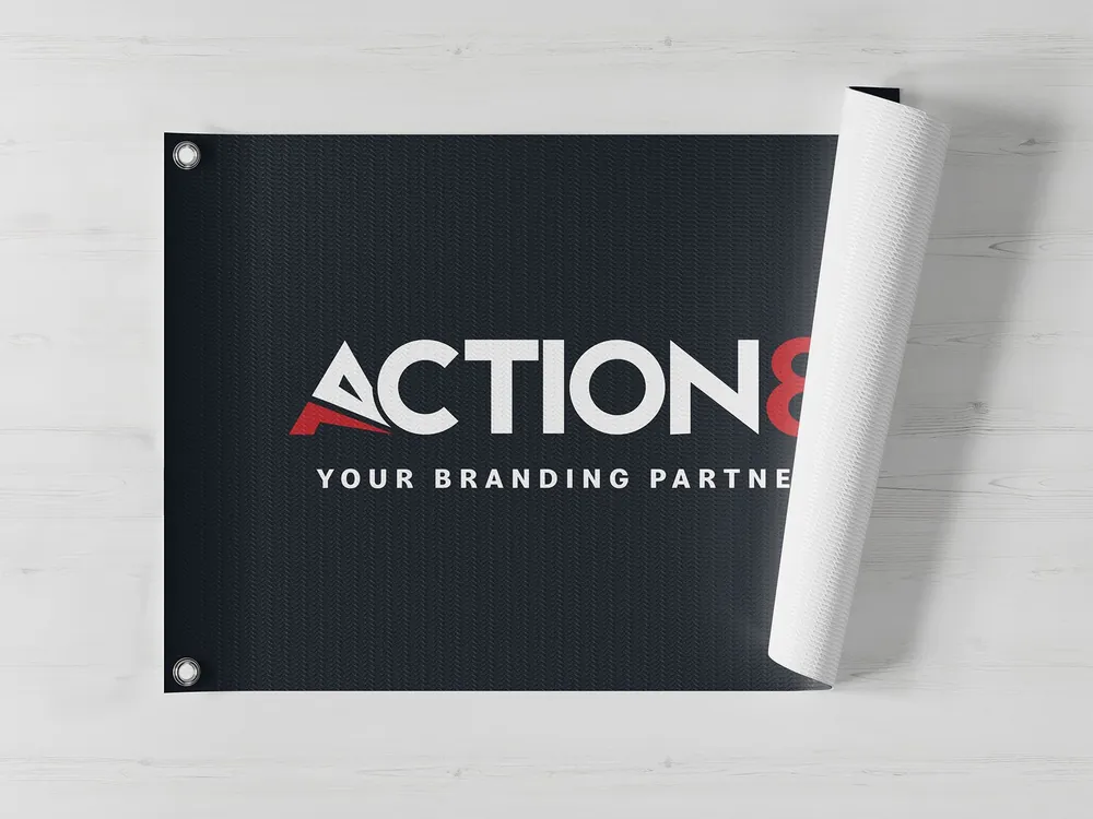 Printed PVC flex banner with eyelets, one corner curling away from the wall